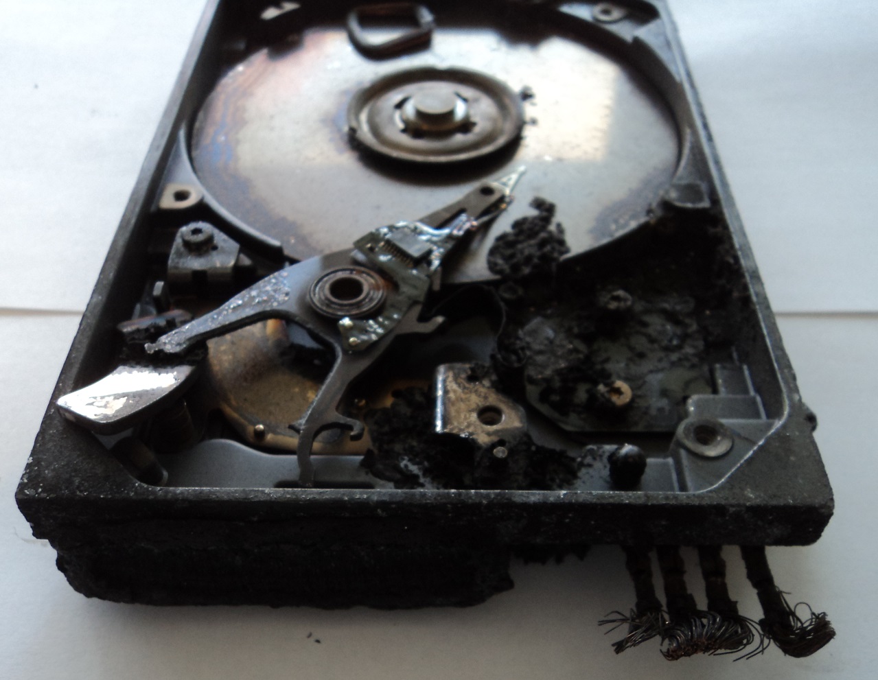 Fire and water damaged hard drive with cover off